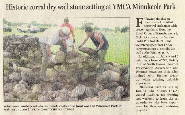 Article clipping from a newspaper it has an image of people working on the rock wall.